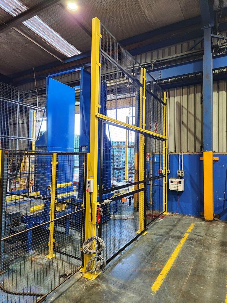 Interlocked guard door and mast enclosure with mesh guarding and lockout tongue